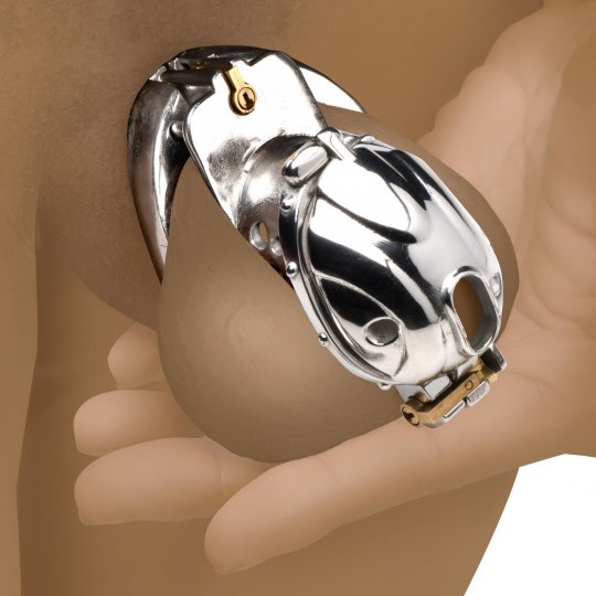 Metallic device resembling a car on a hand against a neutral background